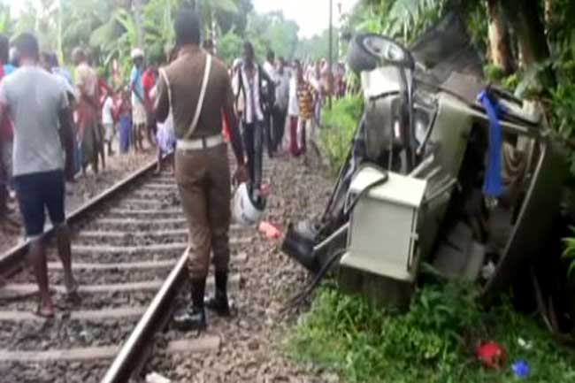 Two dead and two injured as van collides with train