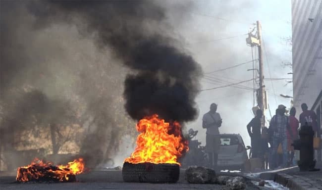 Hundreds of inmates flee after armed gangs storm Haiti’s main prison, leaving bodies behind