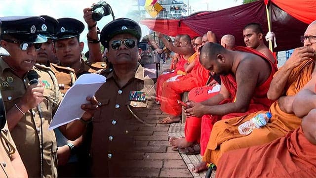 Police serve court order on monks protesting in front of Presidential Secretariat
