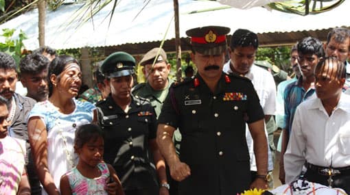 Kilinochchi troops stand behind grieving two Tamil woman soldiers