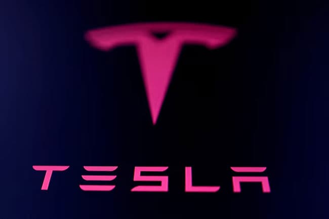 Lawsuit says Musk’s Tesla hires visa holders instead of Americans so it can pay less